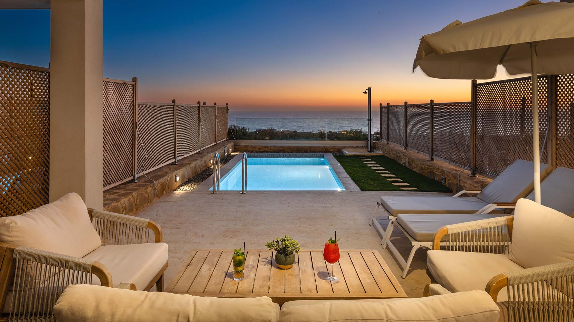 a pool and lounge chairs on a deck