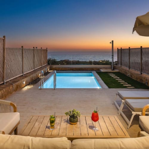 a pool and lounge chairs on a deck