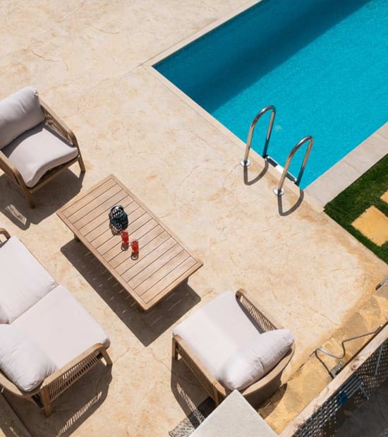 a pool with a bench and chairs