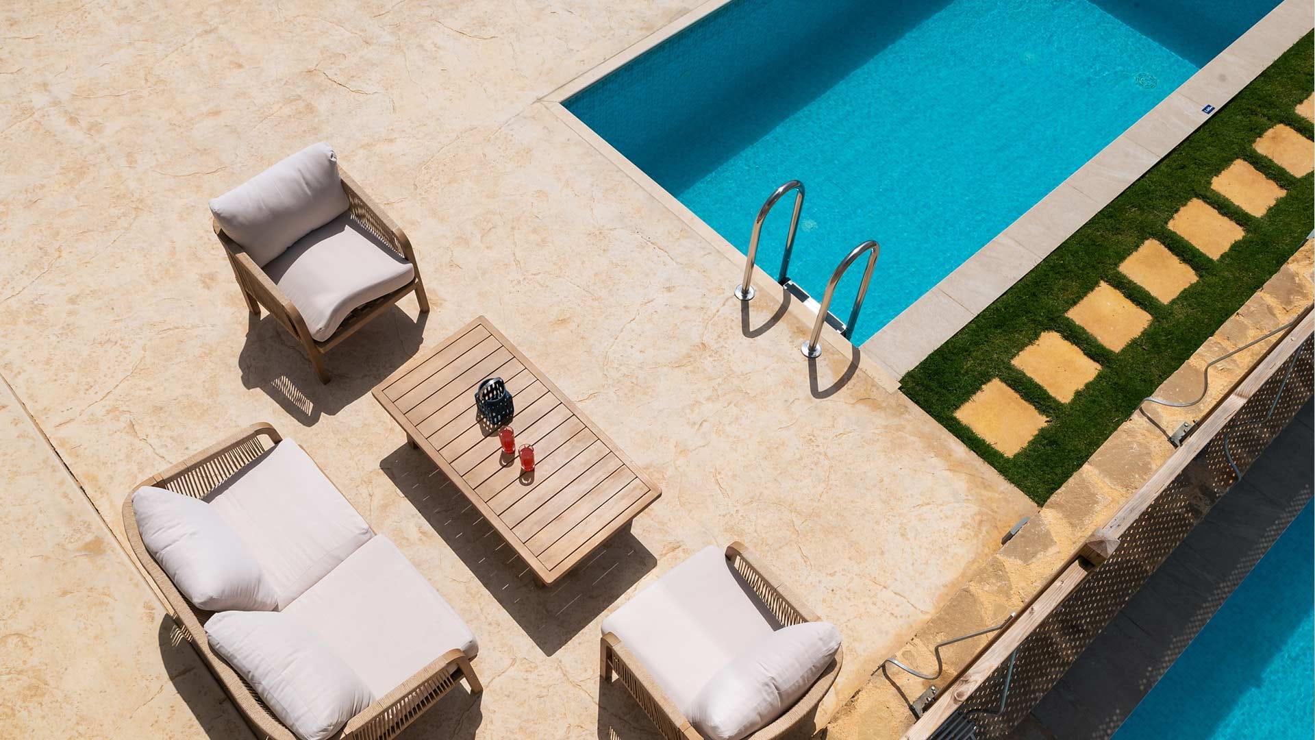 a pool with a lounge chair and a table