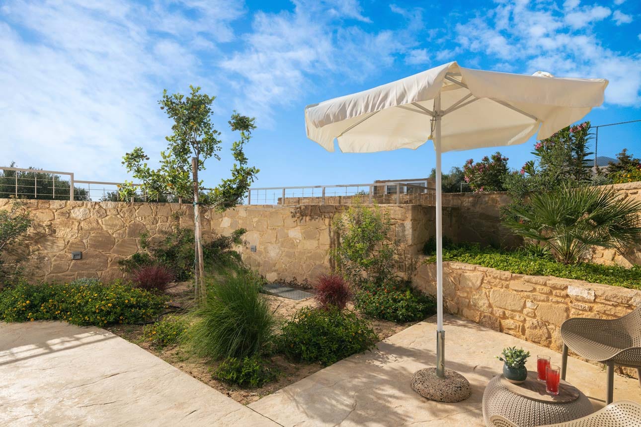 a patio with a white umbrella