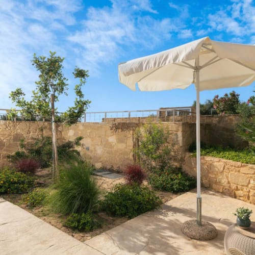 a patio with a white umbrella