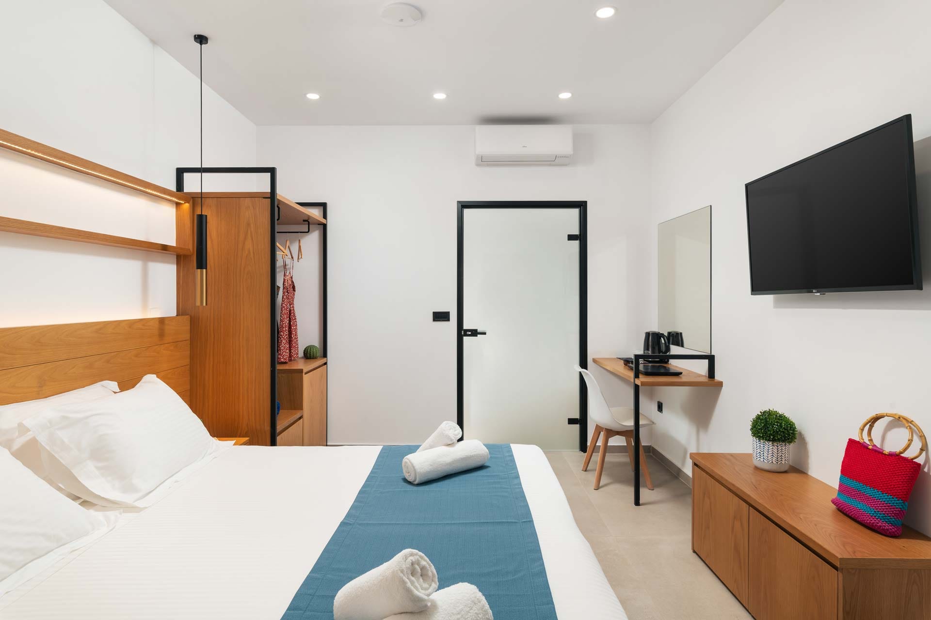 a bedroom with a tv and bed