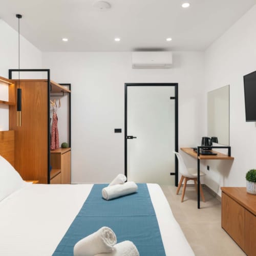 a bedroom with a tv and bed