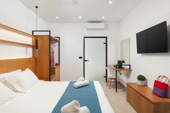 a bedroom with a tv and bed