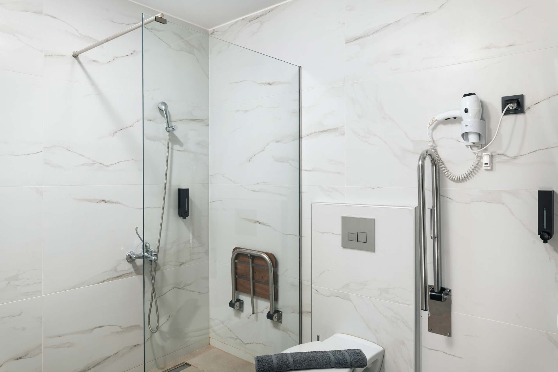 a bathroom with a shower unit and toilet