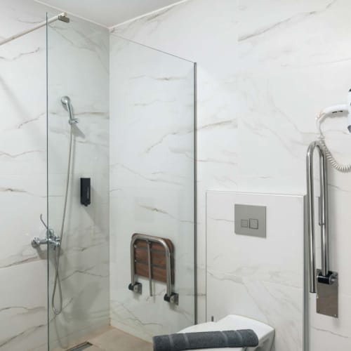 a bathroom with a shower unit and toilet