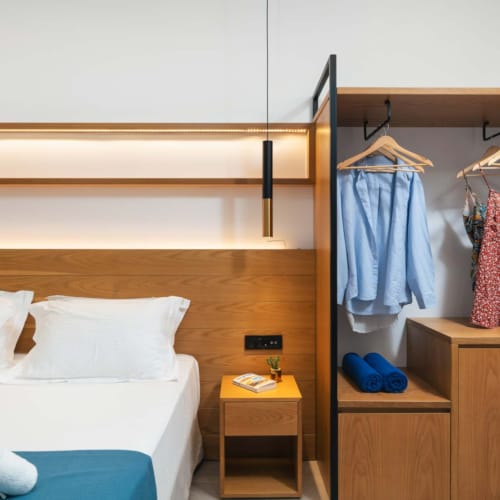 a bedroom with a bed and a mirror