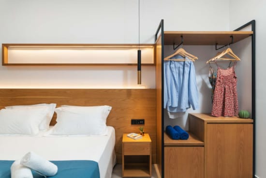 a bedroom with a bed and a mirror