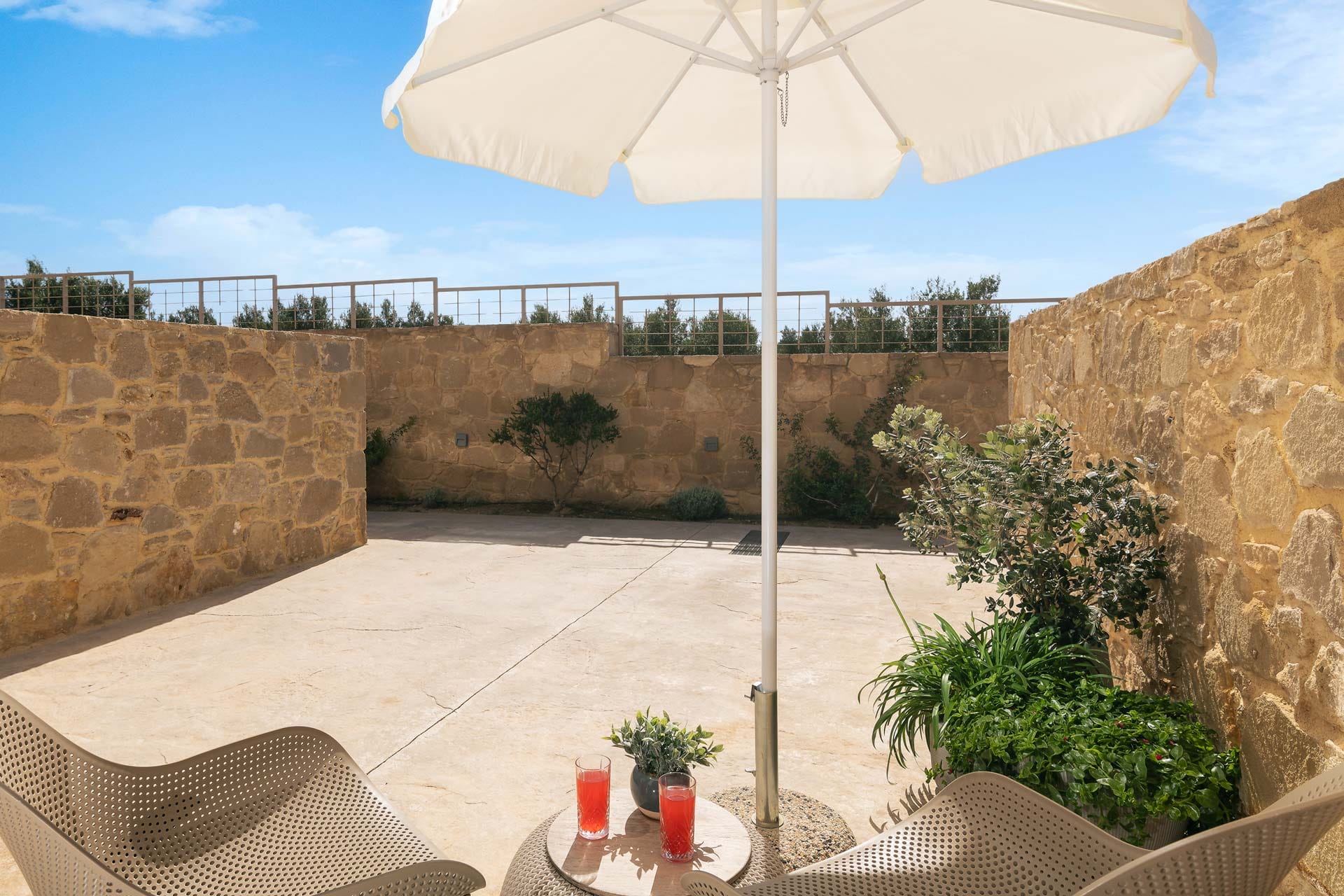 a patio with a table and umbrella