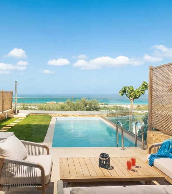 a pool and chairs by a deck