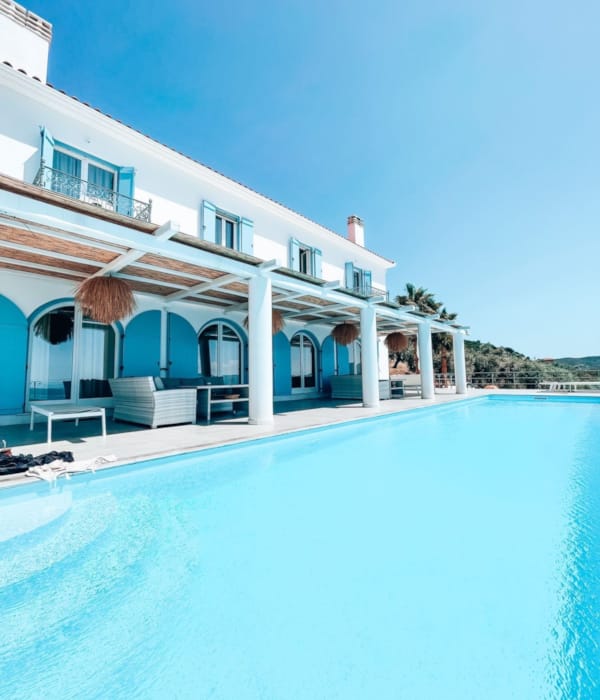 a large white house with a pool