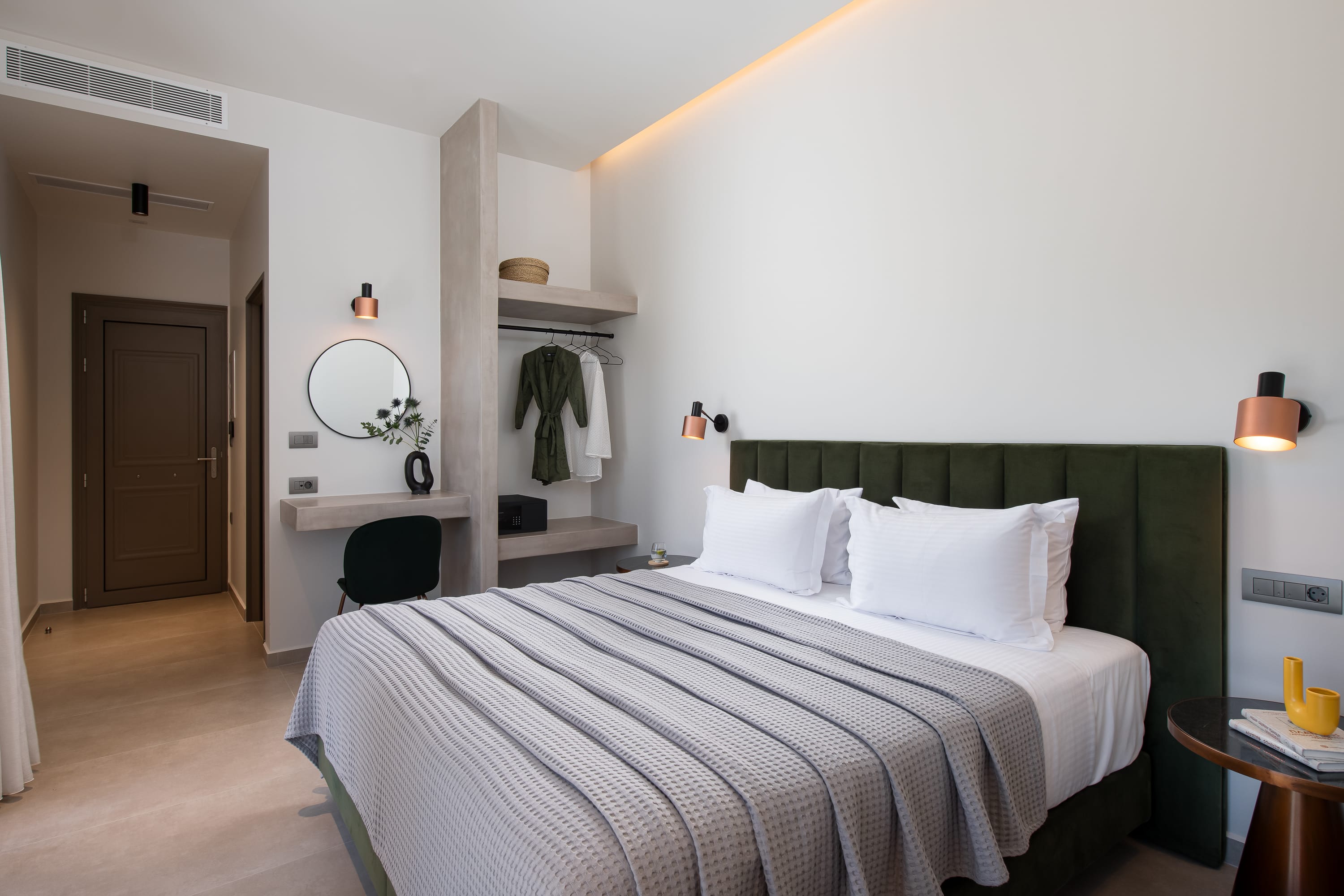 a bedroom with a bed and a mirror