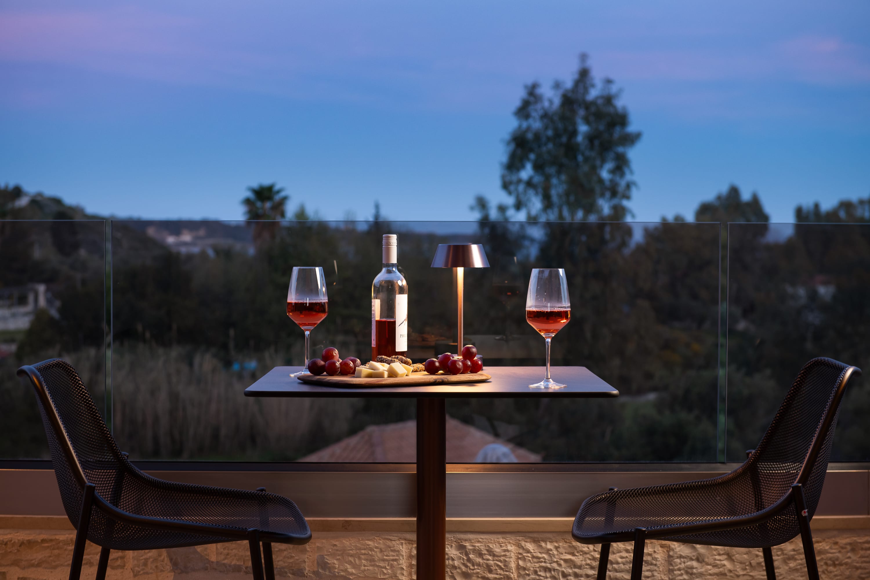 a table with wine glasses and a bottle of wine on it