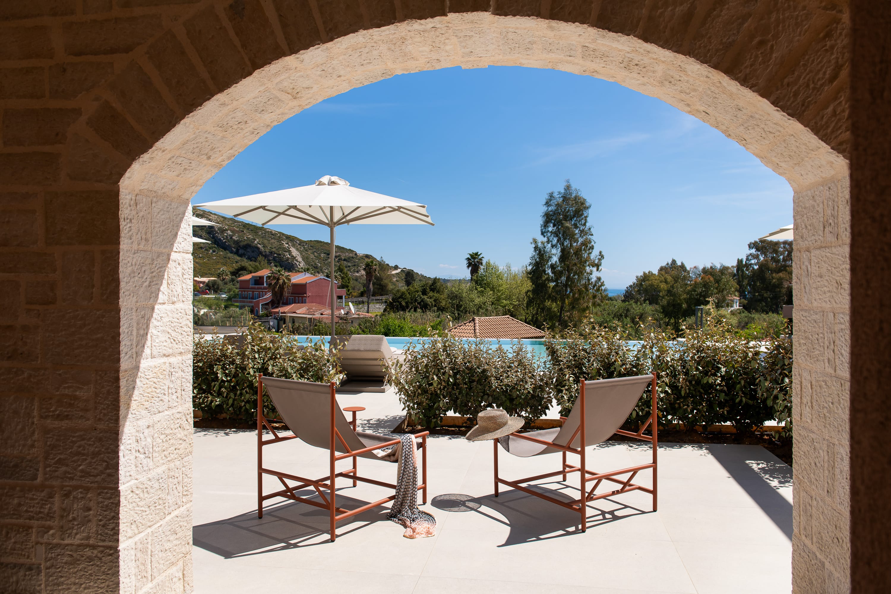 a patio with chairs and umbrella