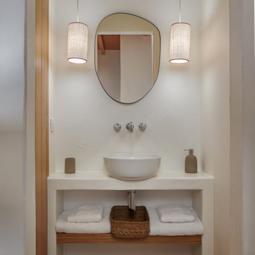 a bathroom with a mirror and a sink