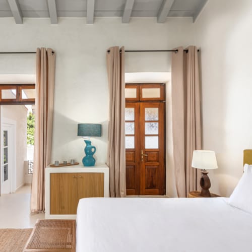 a bedroom with a bed and a lamp