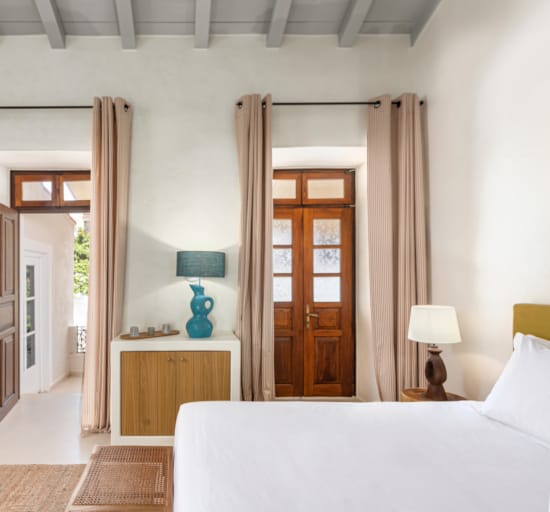 a bedroom with a bed and a lamp