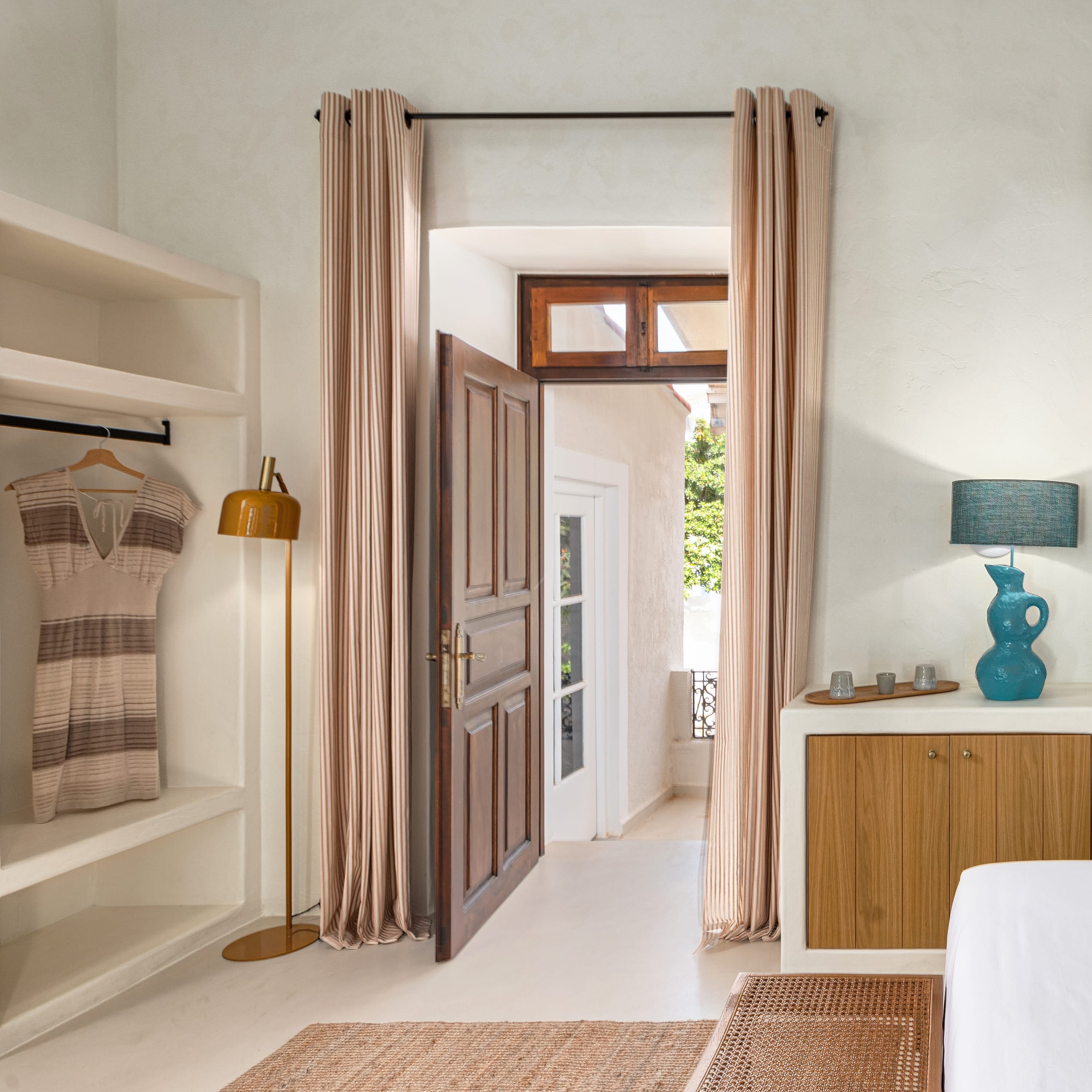 a room with a mirror and a lamp