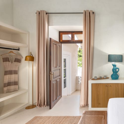 a room with a mirror and a lamp