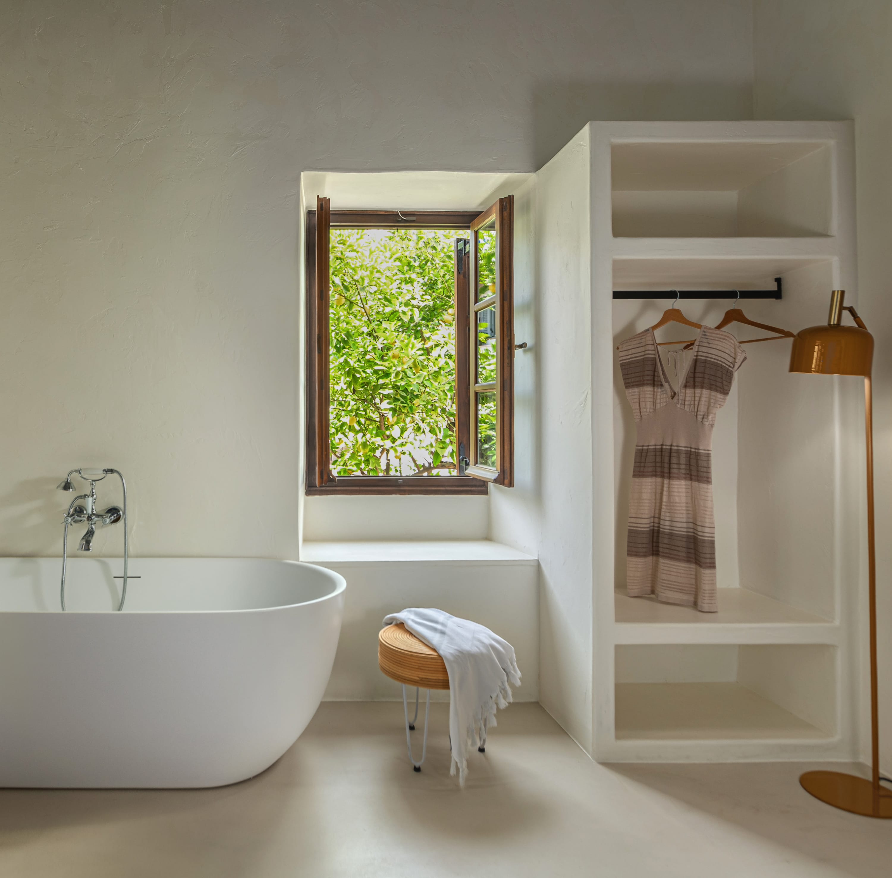 a bathroom with a tub and a window