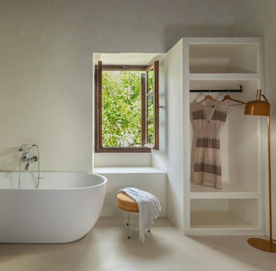 a bathroom with a tub and a window