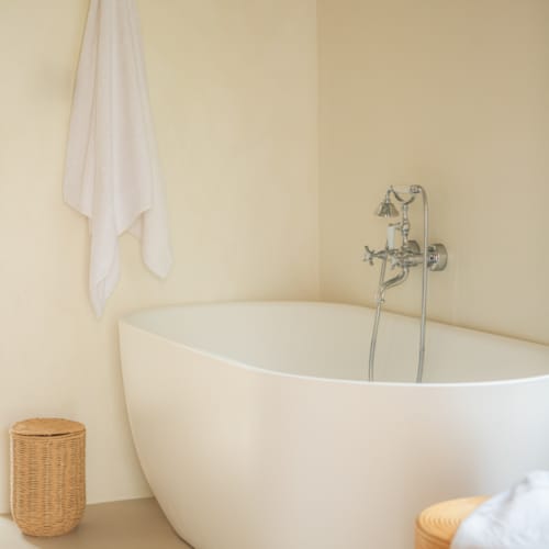 a bathtub with a towel on the wall