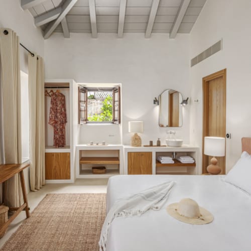 a bedroom with a bed and a table