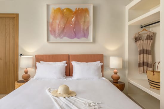 a bed with a painting on the wall