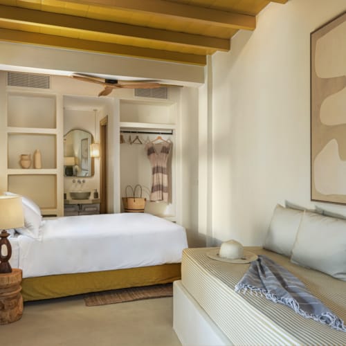 a bedroom with a mirror and a bed