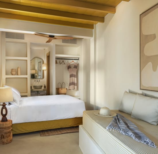 a bedroom with a mirror and a bed