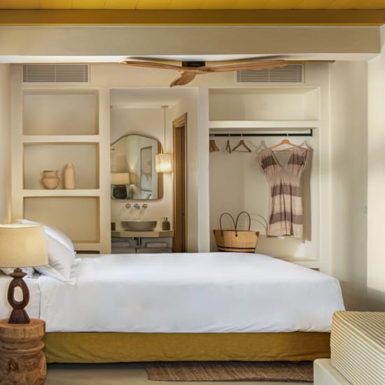 a bedroom with a mirror and a bed