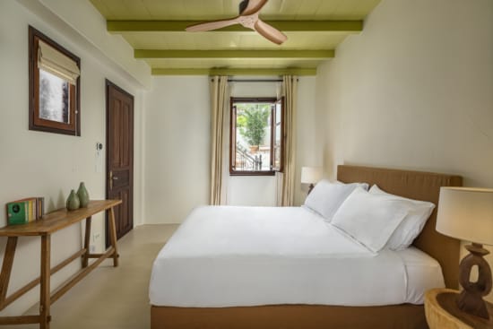 a bedroom with a bed and a table