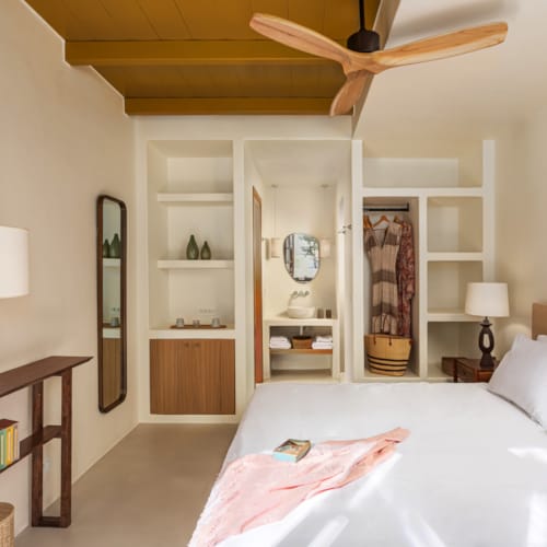 a bedroom with a bed and a shelf