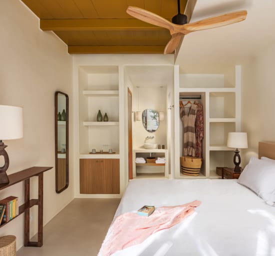 a bedroom with a bed and a shelf