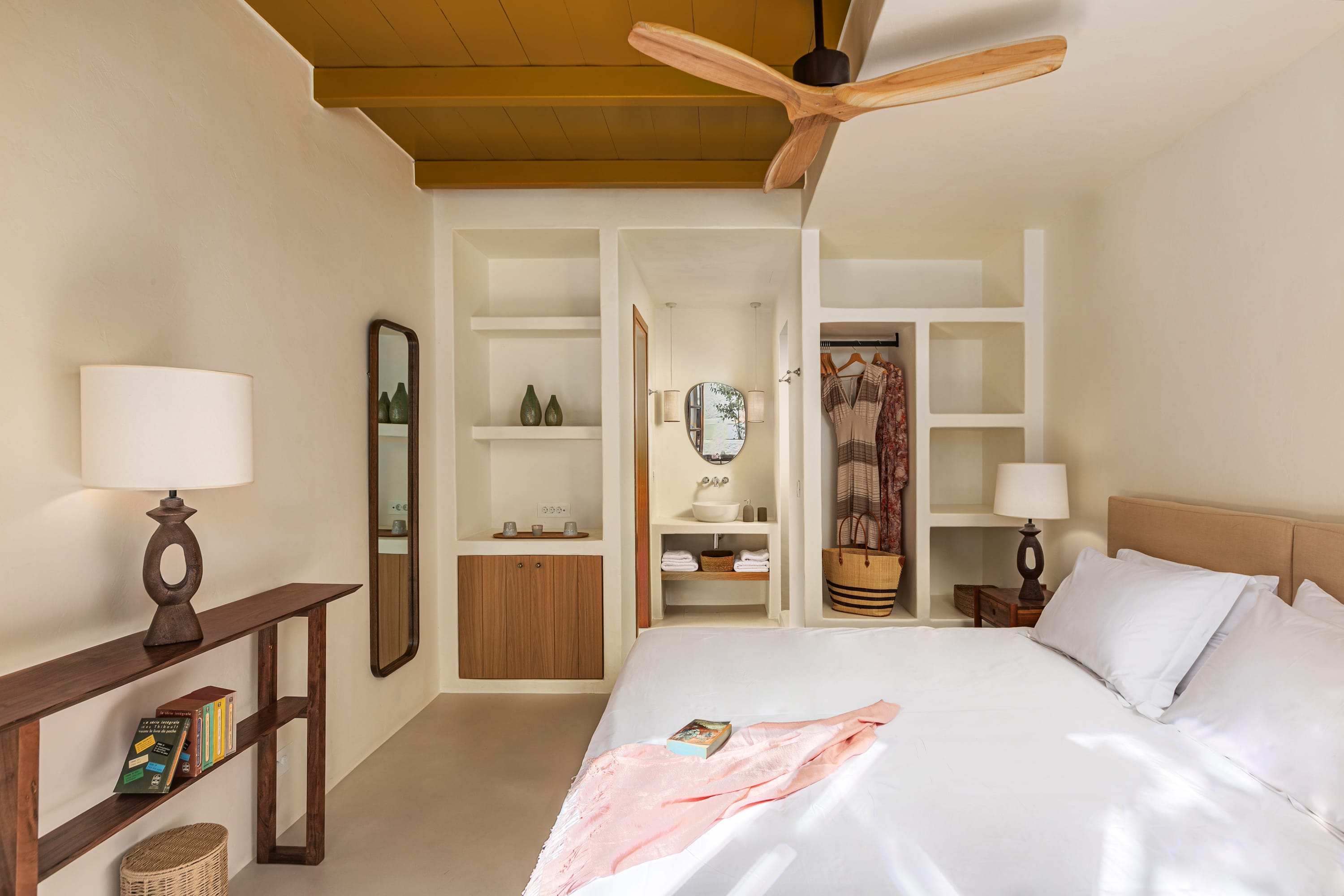 a bedroom with a bed and a book shelf