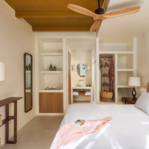 a bedroom with a bed and a book shelf