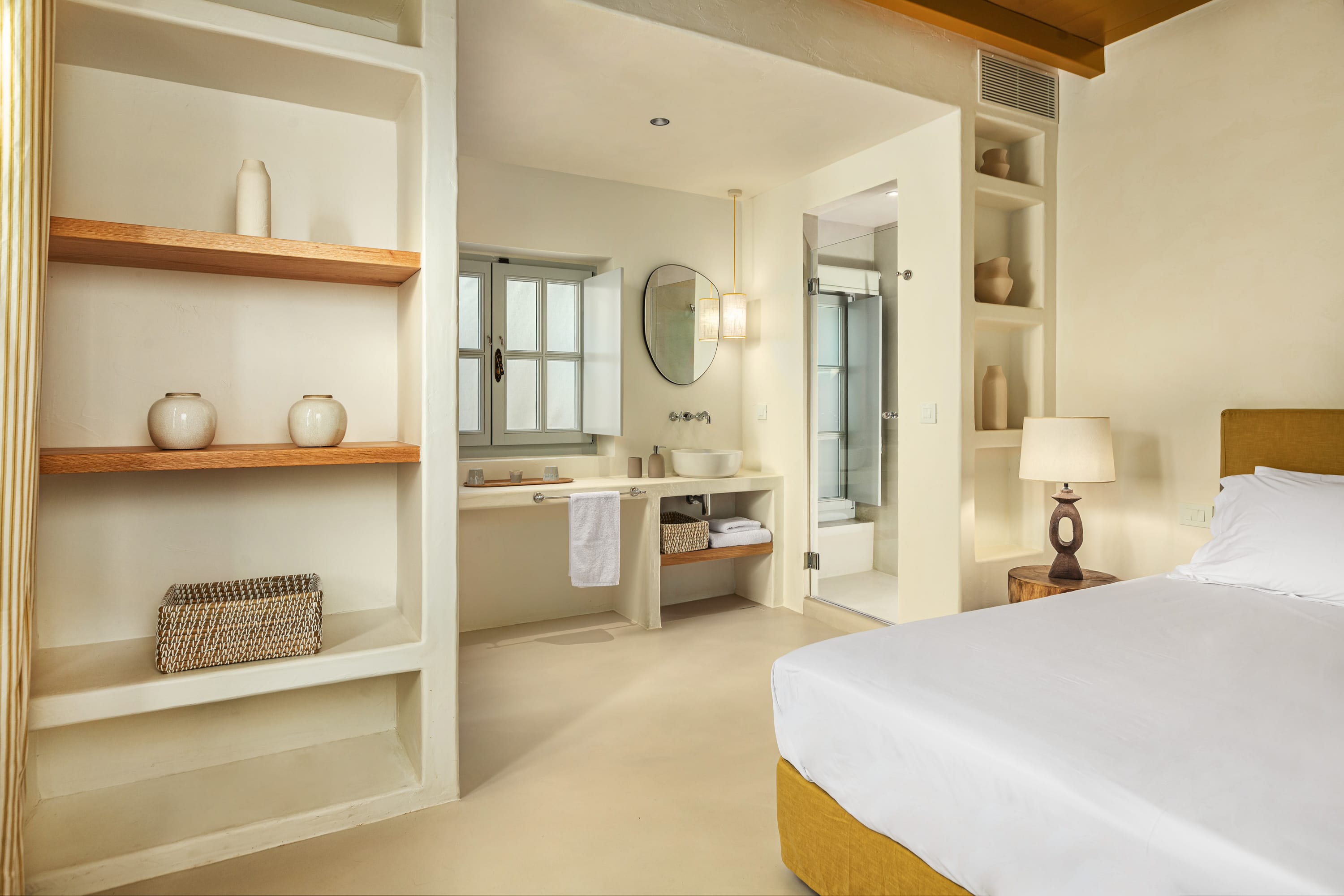 a bedroom with a bed and a shelf