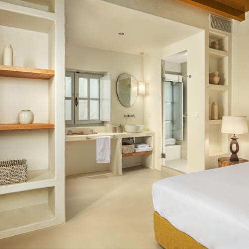 a bedroom with a bed and a shelf