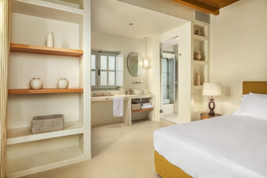 a bedroom with a bed and a shelf