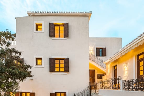 a white building with a tree in front of it