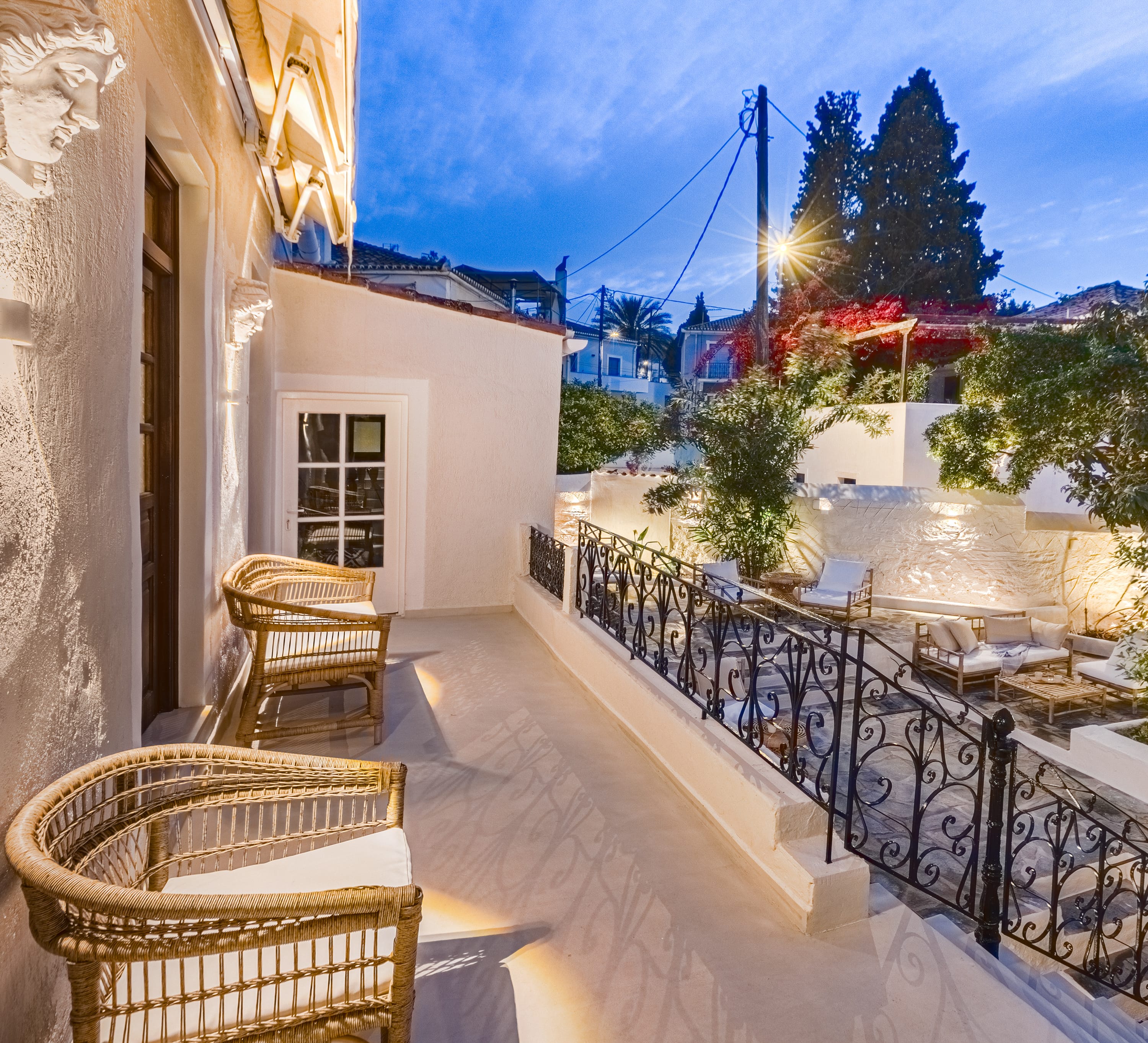a patio with chairs and tables on it next to a building
