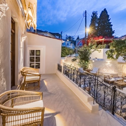 a patio with chairs and tables on it next to a building