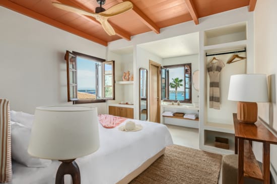 a bedroom with a bed and a lamp