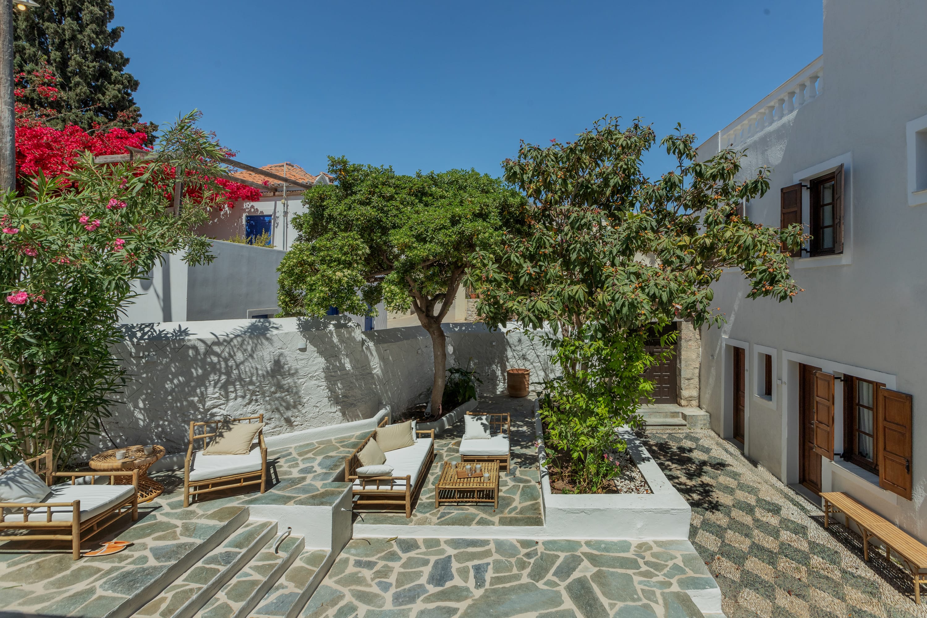a patio with trees and chairs