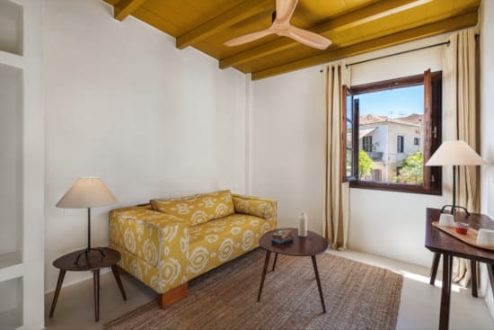 a living room with a yellow couch