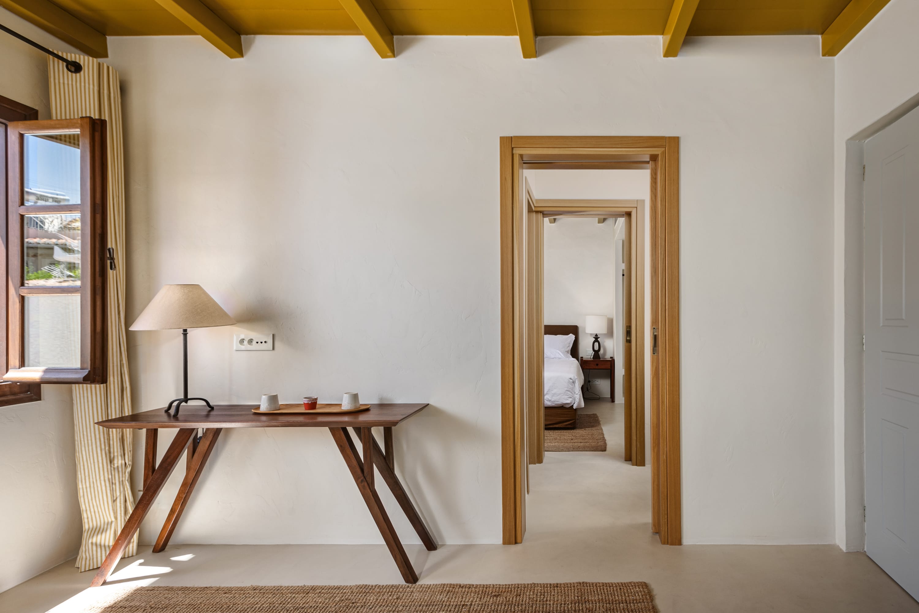 a room with a table and a lamp