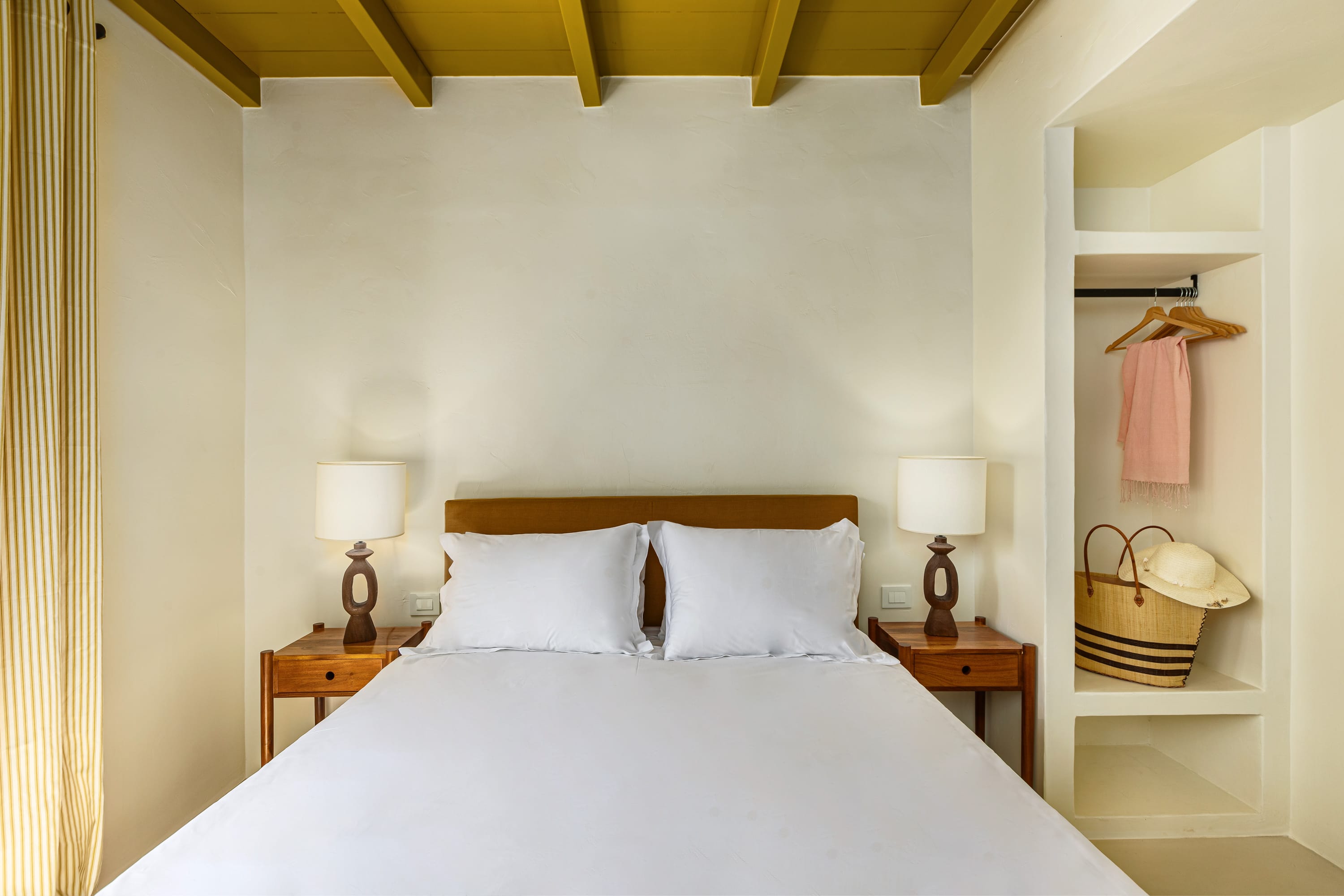 a bed with a lamp on the side