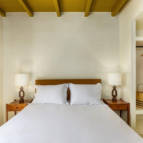 a bed with a lamp on the side