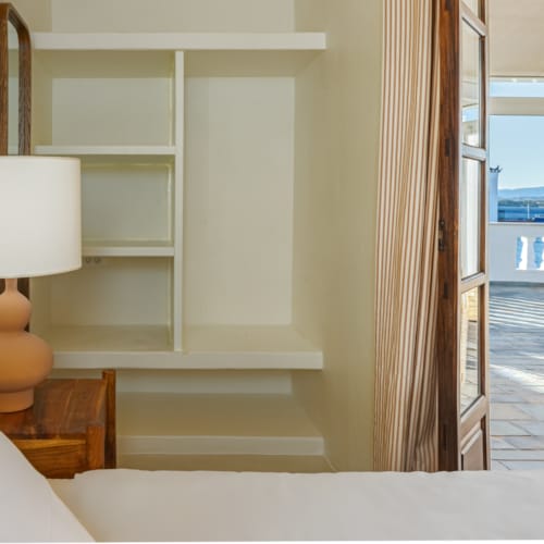 a room with a lamp and a window